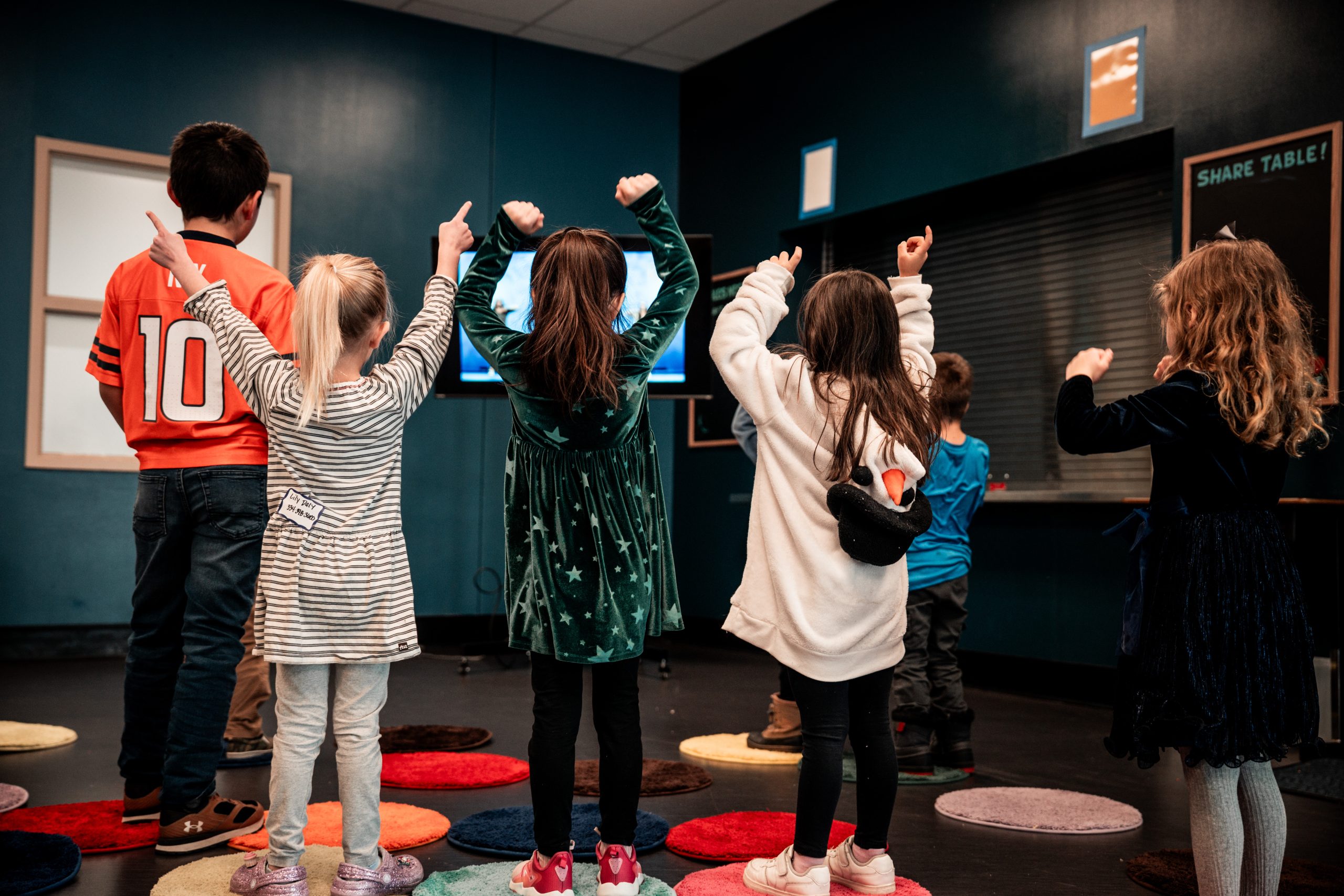 Children worshiping with hands raised in Valor Kids ministry at Valor Church Arvada